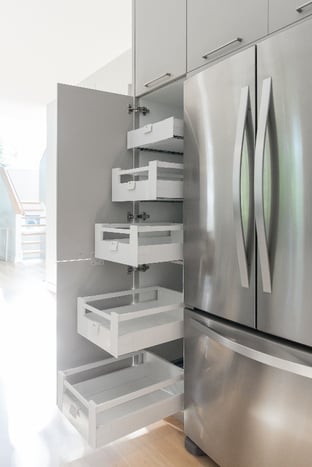 A roll-out pantry within a cabinetry system.