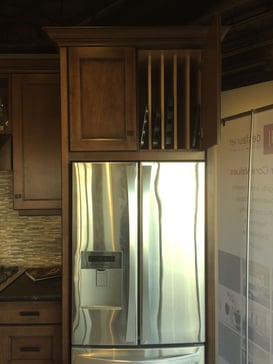 A tray divider above a fridge.