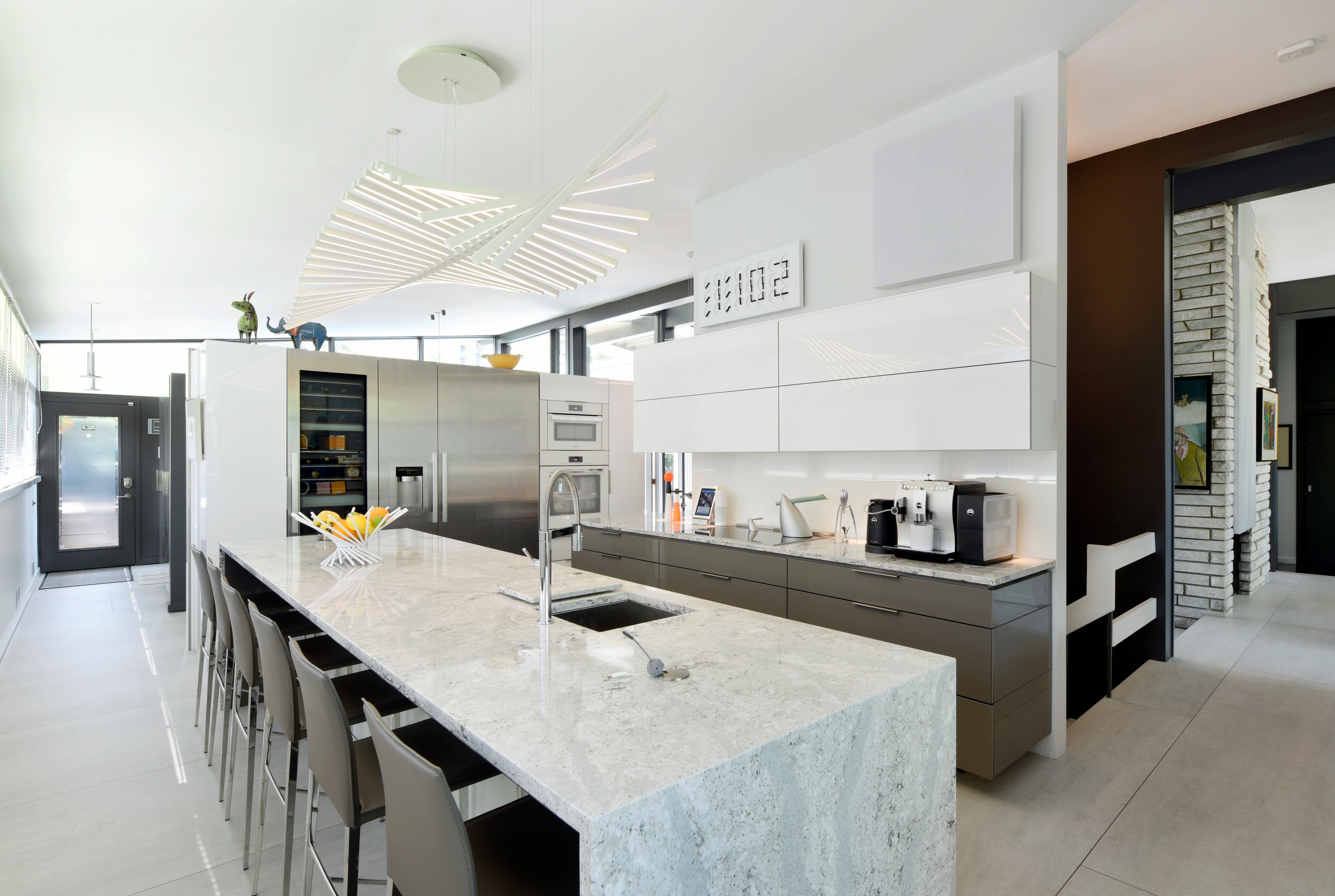 A row of modern bar stools in an upscale kitchen.