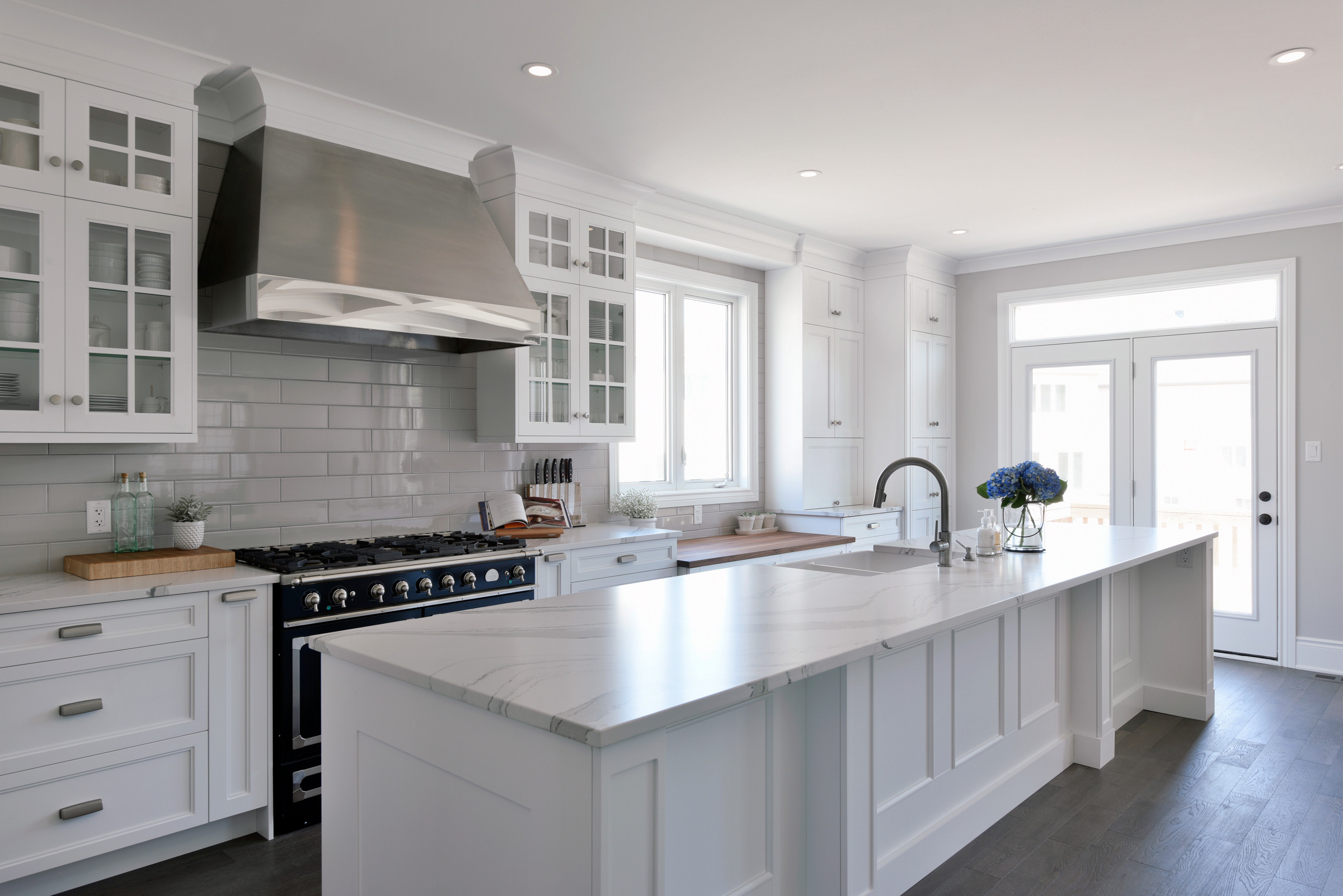 A kitchen with upper glass-front cabinets.