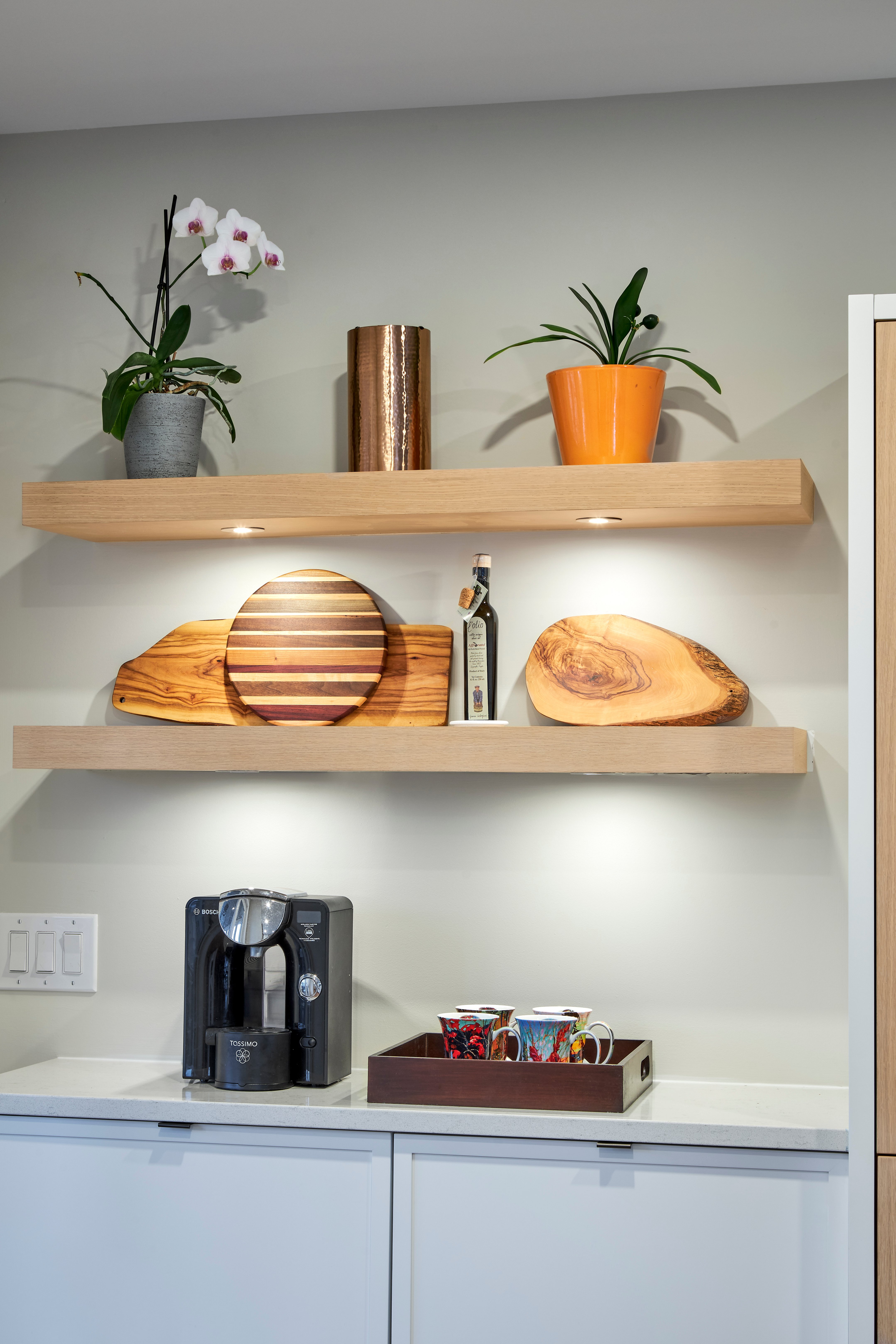 Lights integrated to the underside of floating shelves.