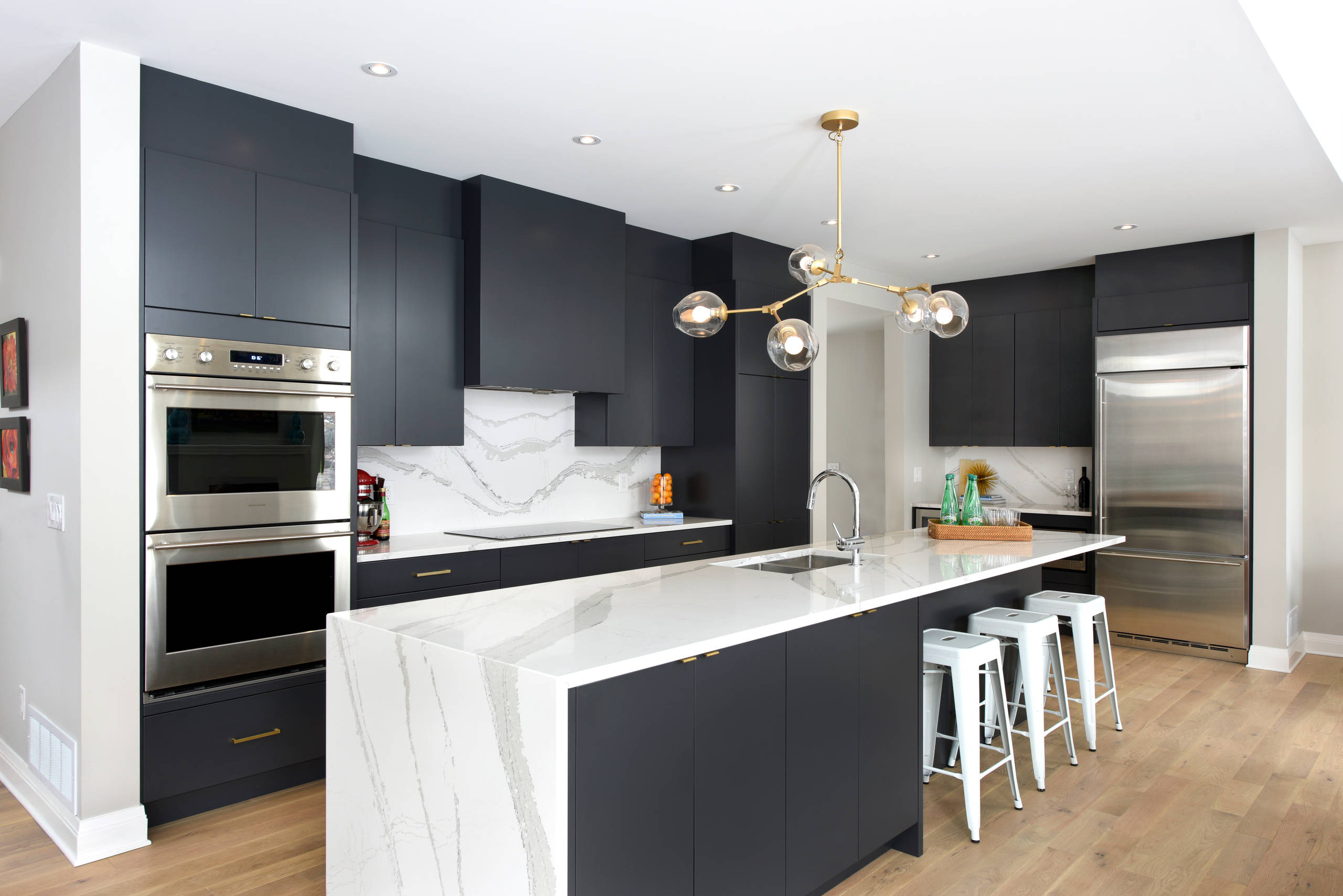 A custom kitchen using bulkhead trim for ceiling-height cabinets.