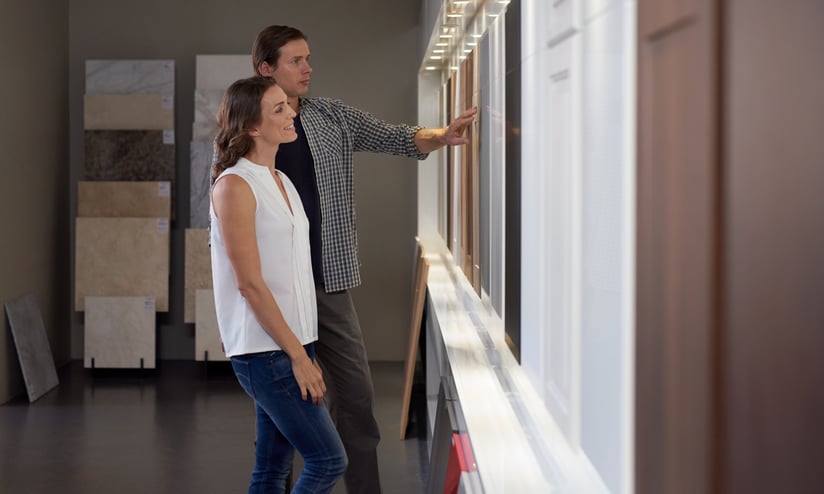 Homeowners exploring kitchen design options in a showroom.