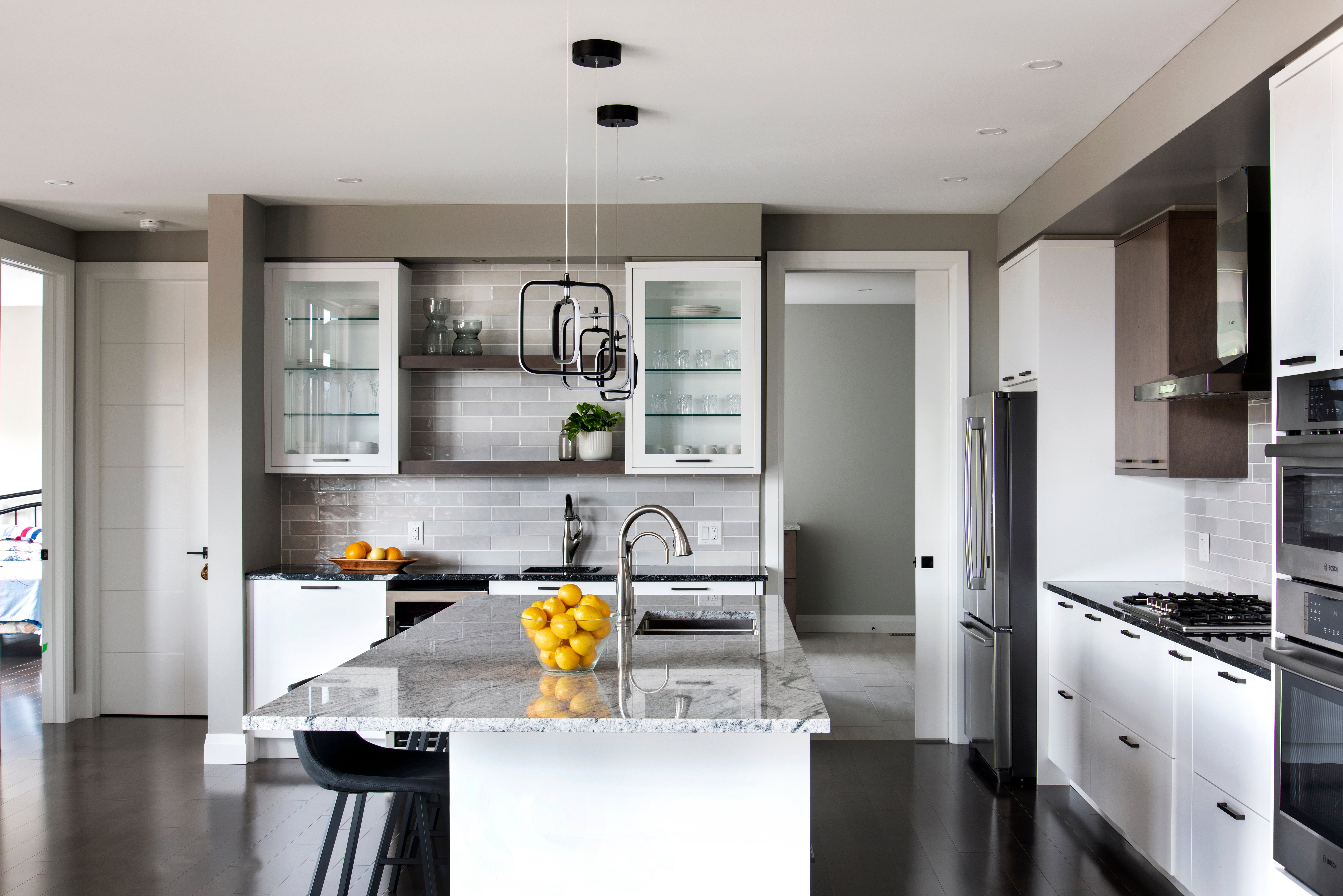 A Deslaurier kitchen with a neutral colour scheme, accented with bright fruit display pieces.