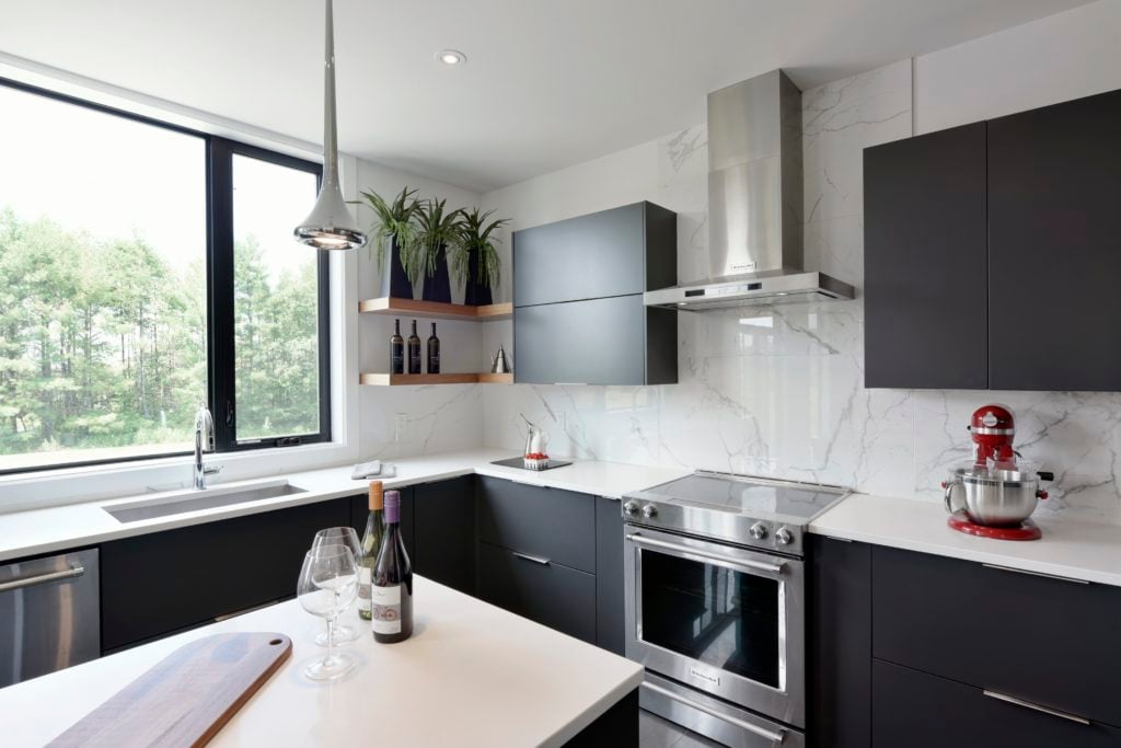 An upscale kitchen featuring modern Deslaurier cabinets.