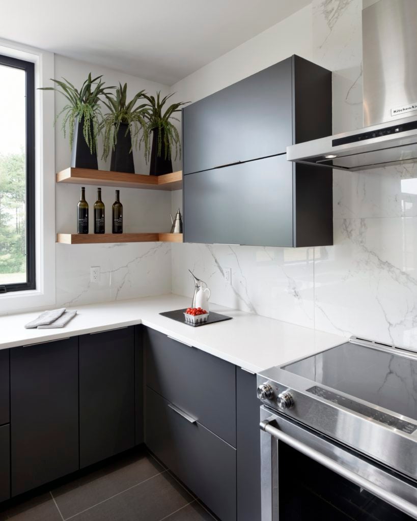 Long drawer pulls on modern black custom cabinets.