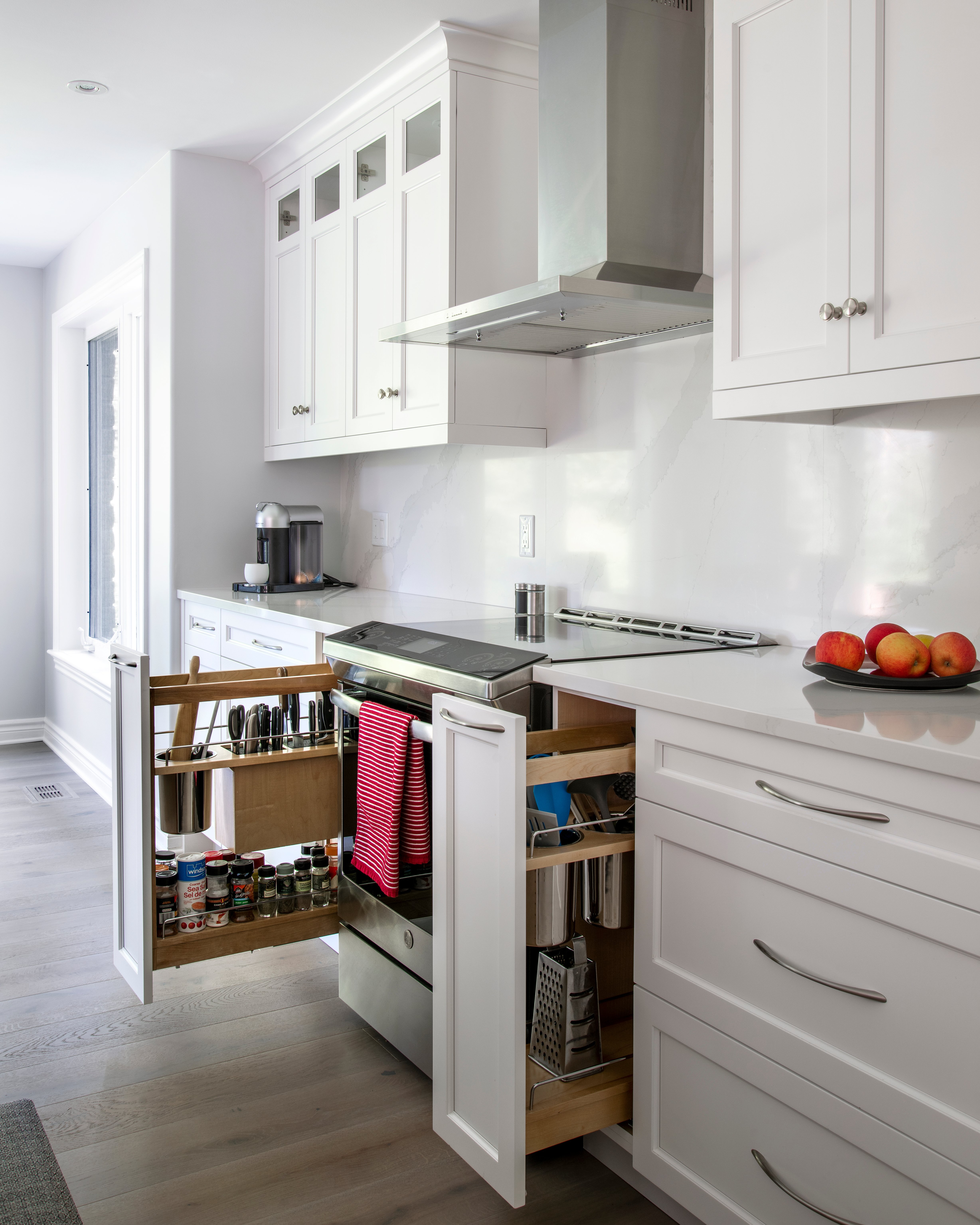 Lower cabinets featuring pull-out spice racks and utensil holders.