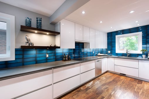 A bold and blue backsplash livens up a clean kitchen area.