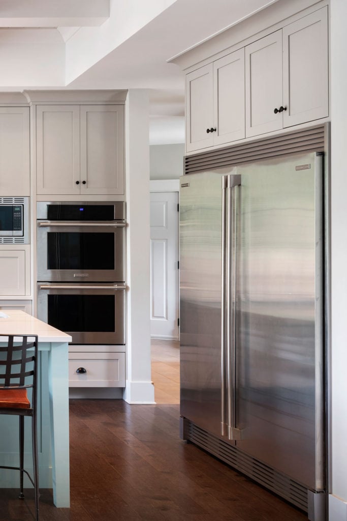 A double-door fridge built into custom cabinetry.