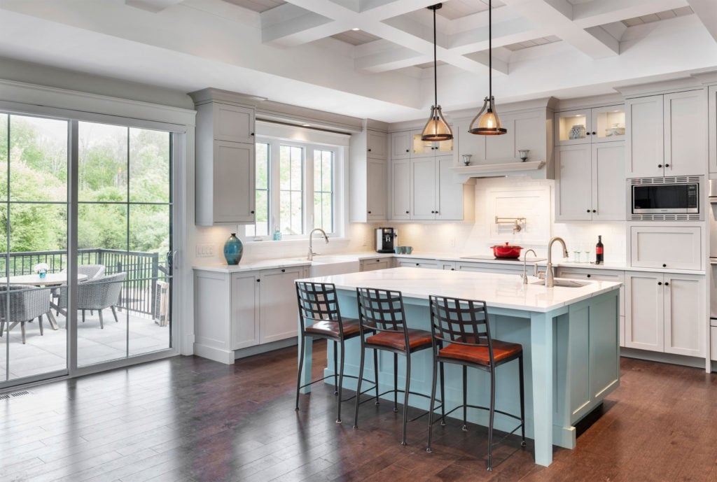 A two-toned kitchen with a bright blue island.