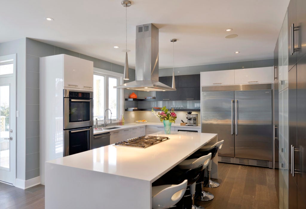 A Deslaurier kitchen with stainless steel appliances, including a double-door fridge.