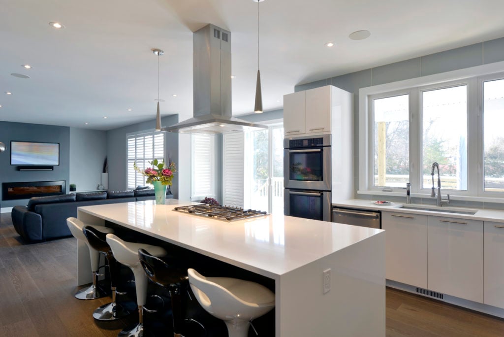 A kitchen with a cooktop on the island.