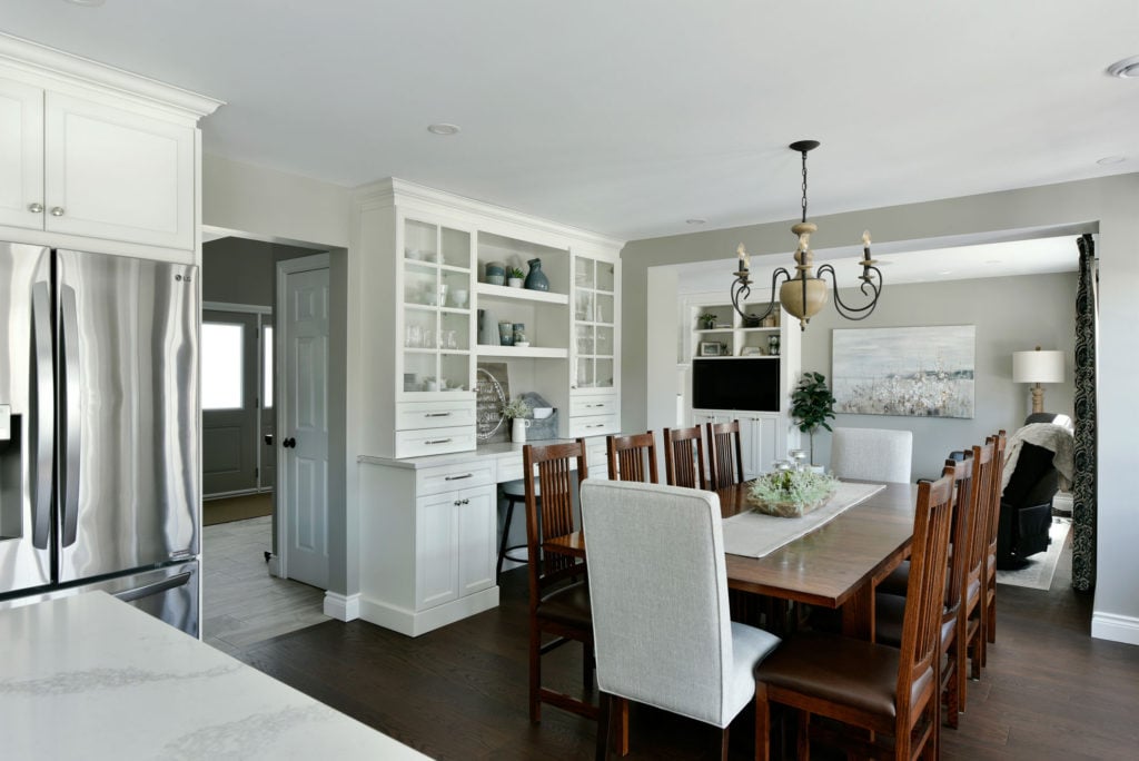 White cabinetry with glass inserts in a traditional kitchen. 