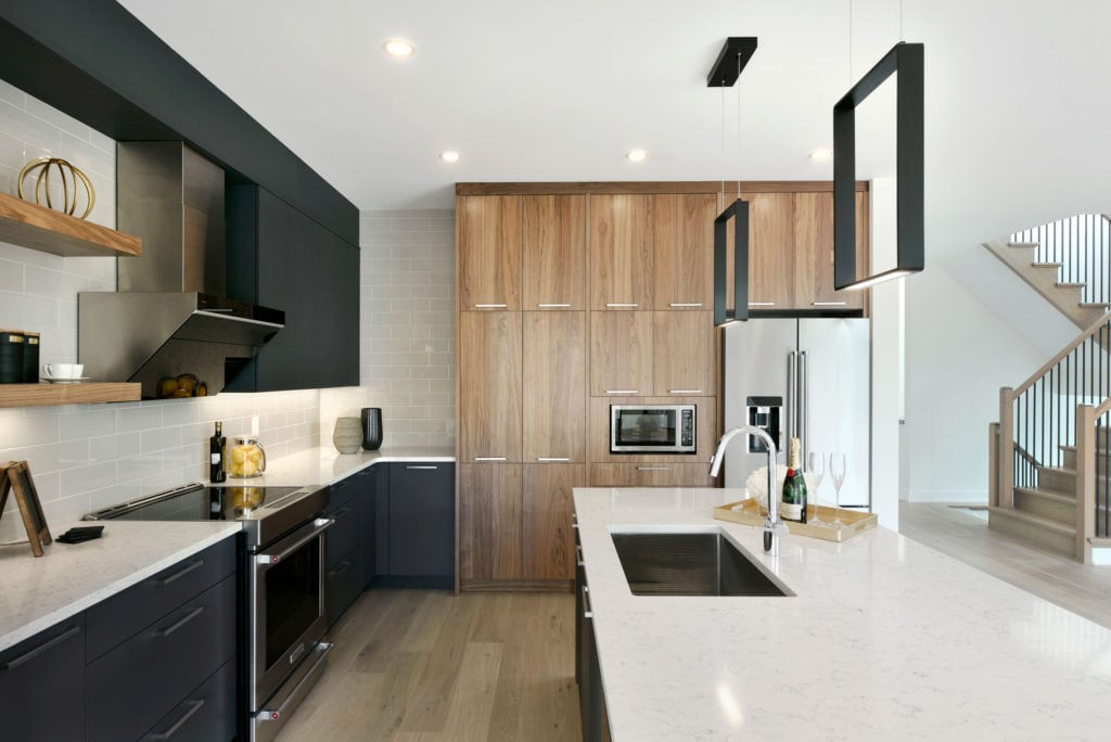 A two-toned kitchen with light and dark cabinets.
