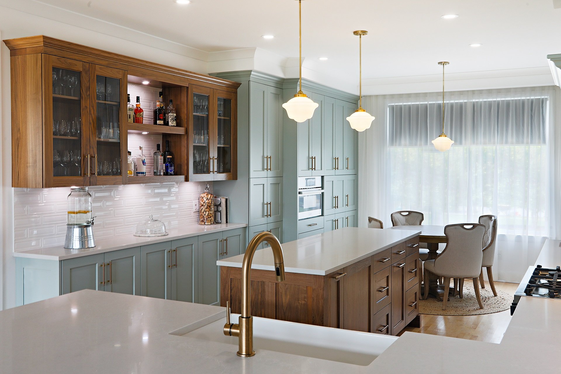 A kitchen featuring warm pendant and under cabinet lights.