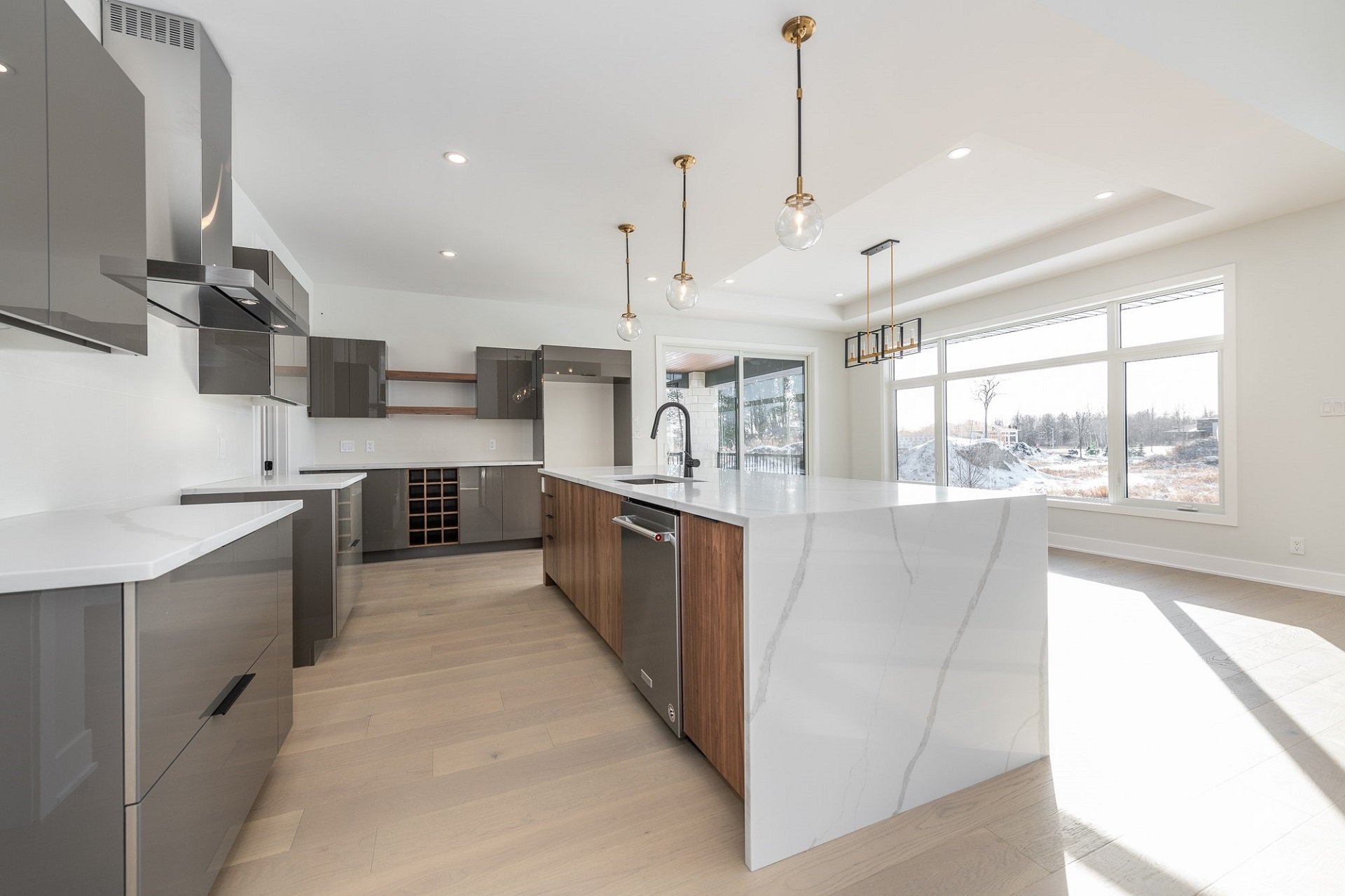 A kitchen featuring Acrylux cabinets in Grey.