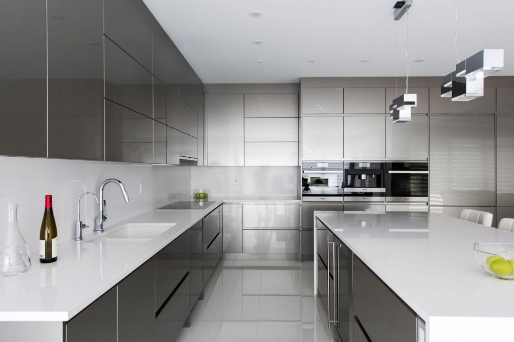 An ultra-modern kitchen design with streamlined, grey cabinets.