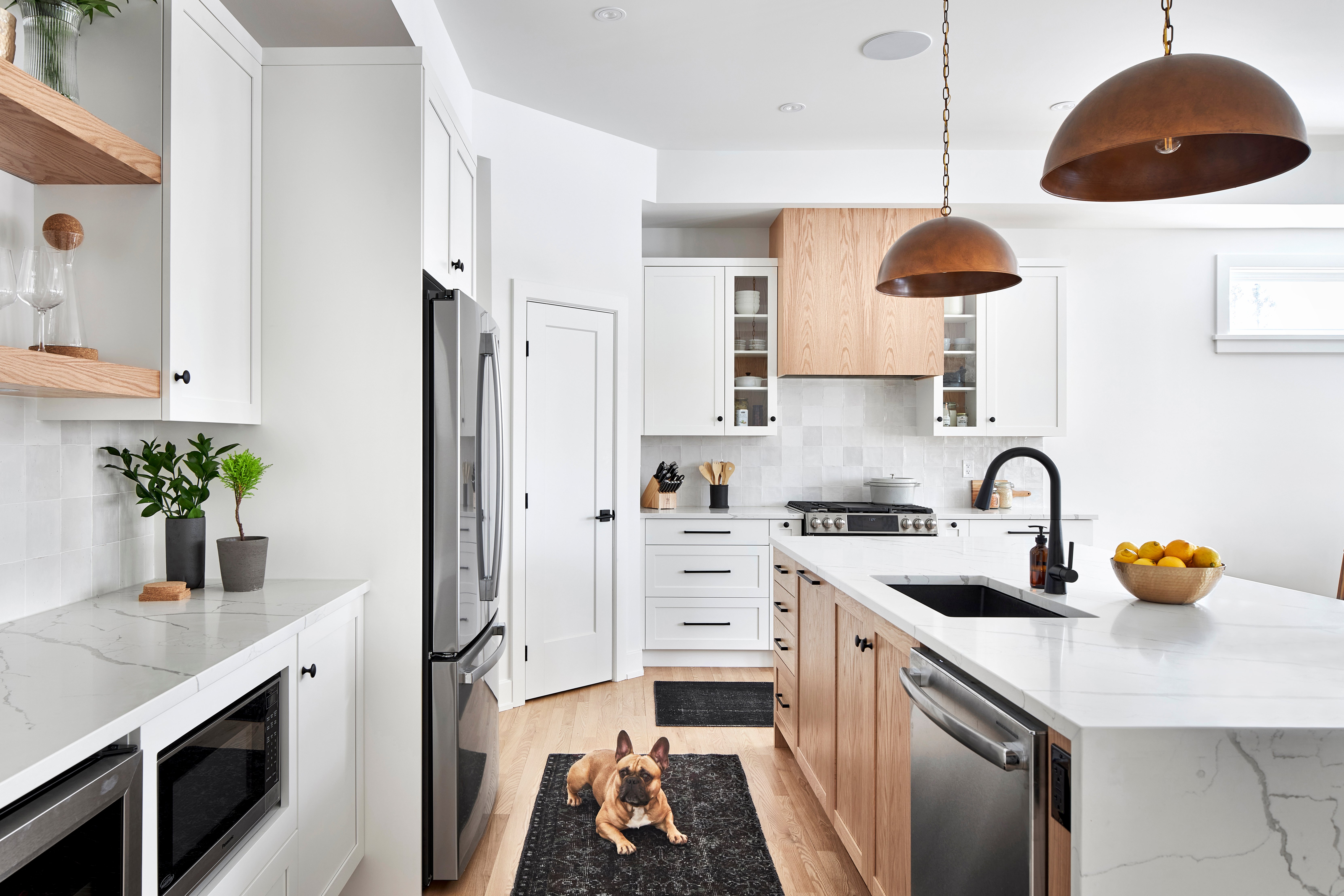 Oversized bronze pendant lights over a kitchen island.