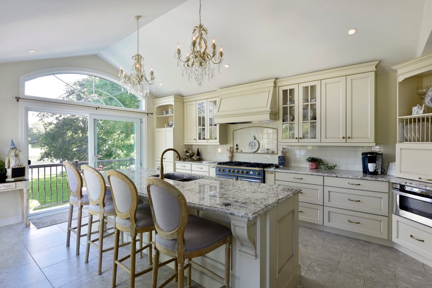 A traditional kitchen with a flecked granite countertop.