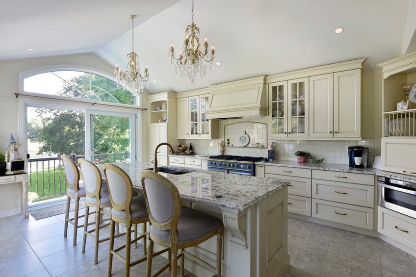 A traditional kitchen with a flecked granite countertop.
