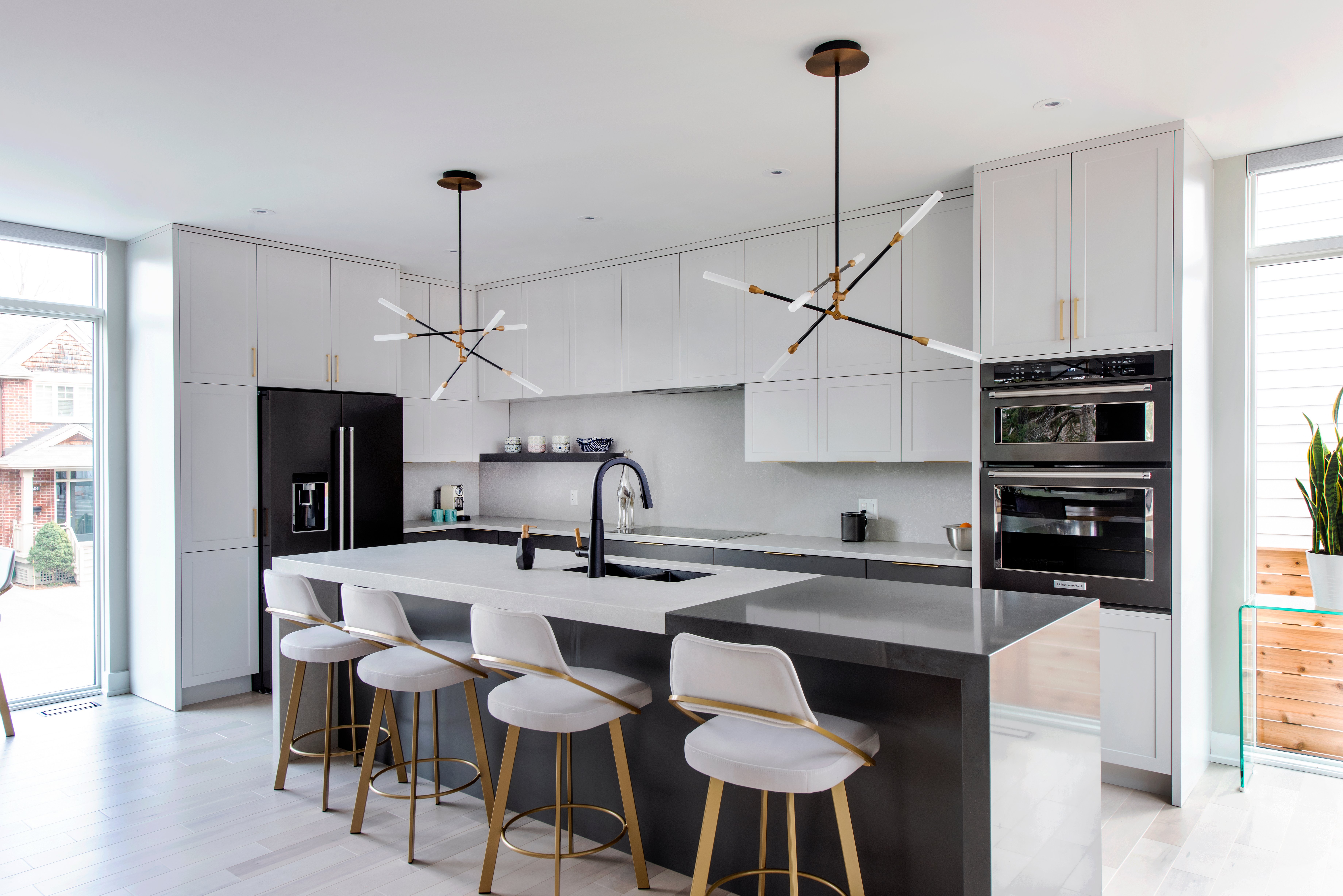 A two-toned quartz waterfall countertop in a Deslaurier kitchen.