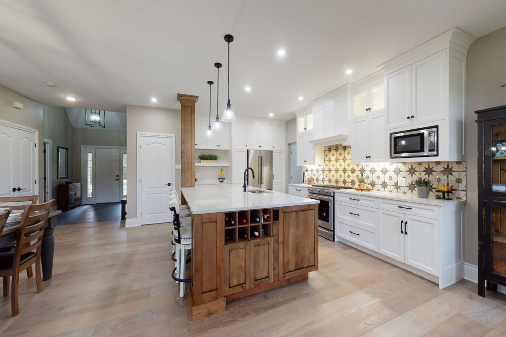 A kitchen with an open floor plan and lots of seating.