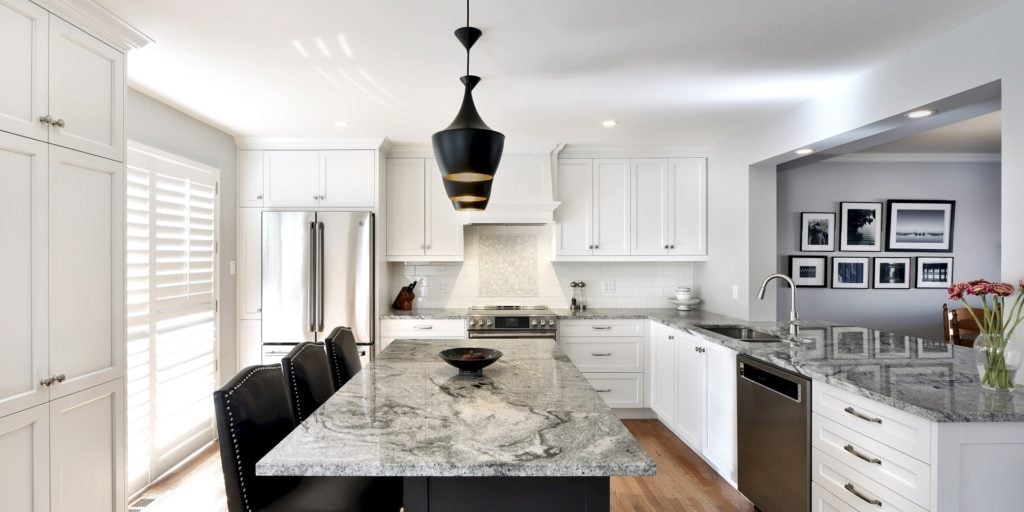 A traditional kitchen with a heavily veined countertop.