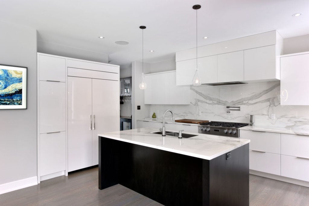 A white kitchen design featuring custom cabinets by Deslaurier