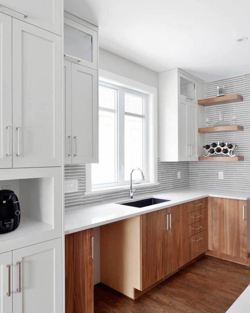 A kitchen design with stacked cabinets.