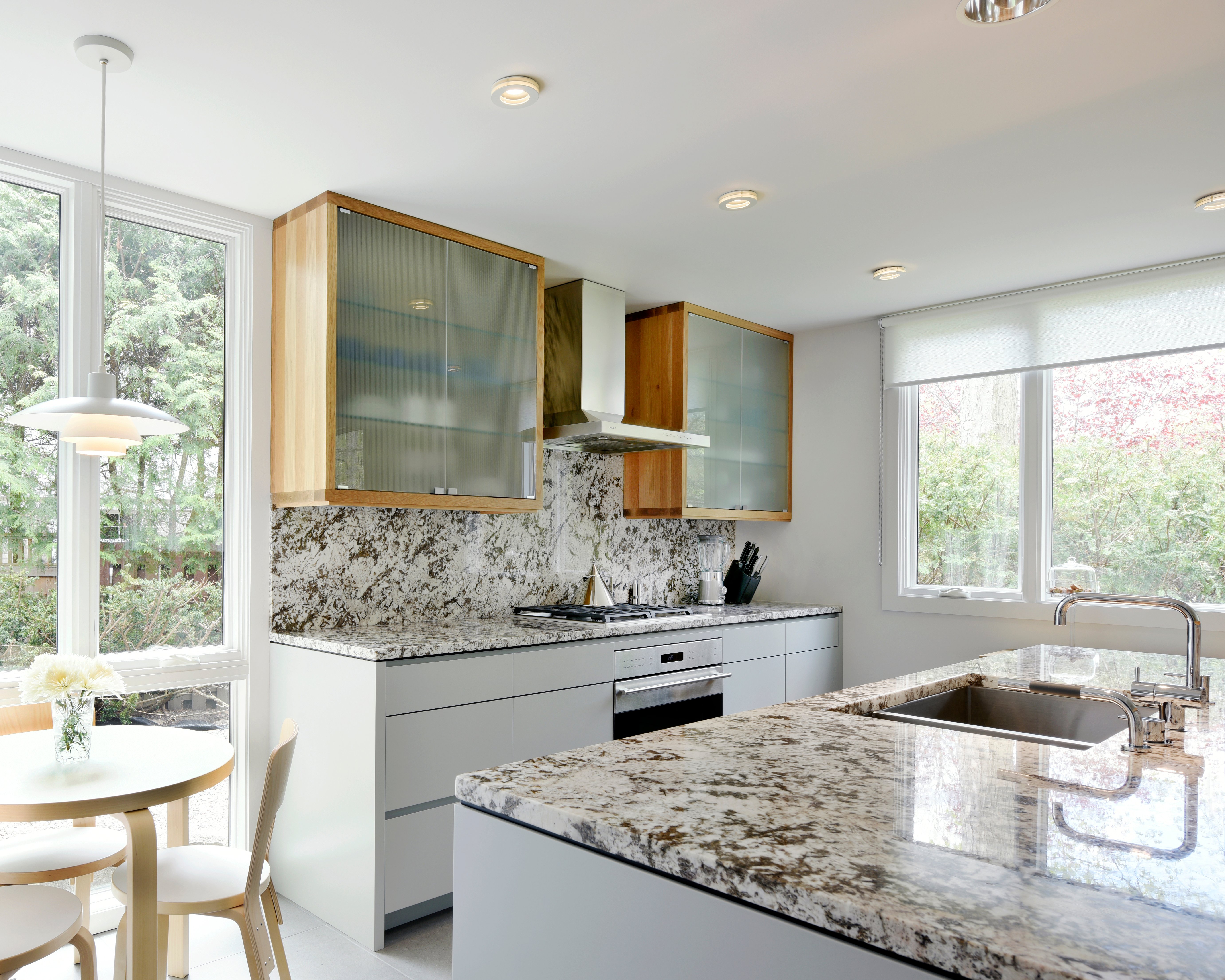 A Deslaurier kitchen design featuring a full-height speckled backsplash.