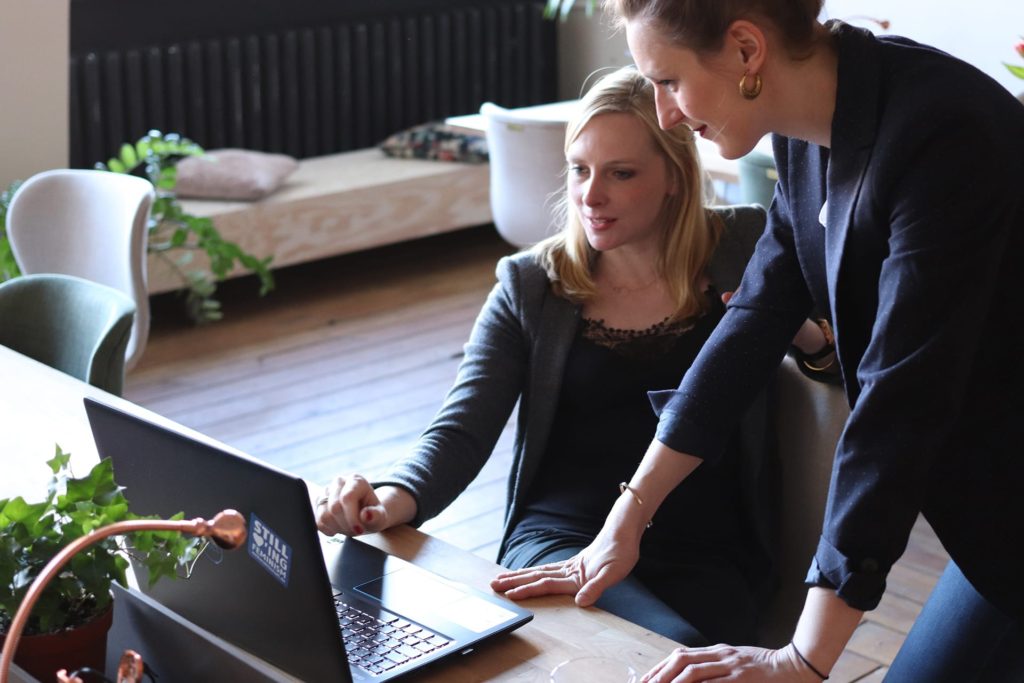 A designer collaborating with a client on a kitchen design.