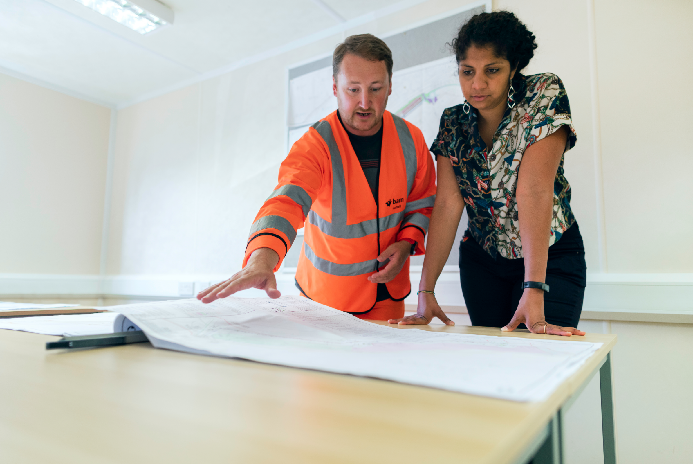 A contractor showing a client construction plans.