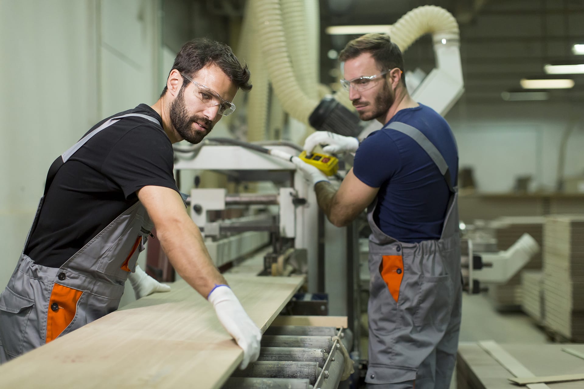 Factory workers manufacturing custom cabinets.